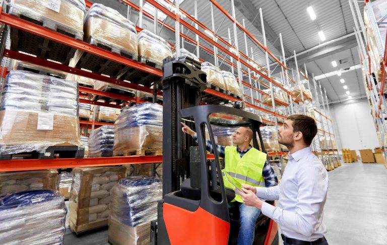 Industrial warehouse with stacked pallets and storage racking